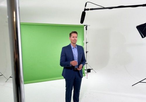 Avon Kettner hosts in front of a green screen